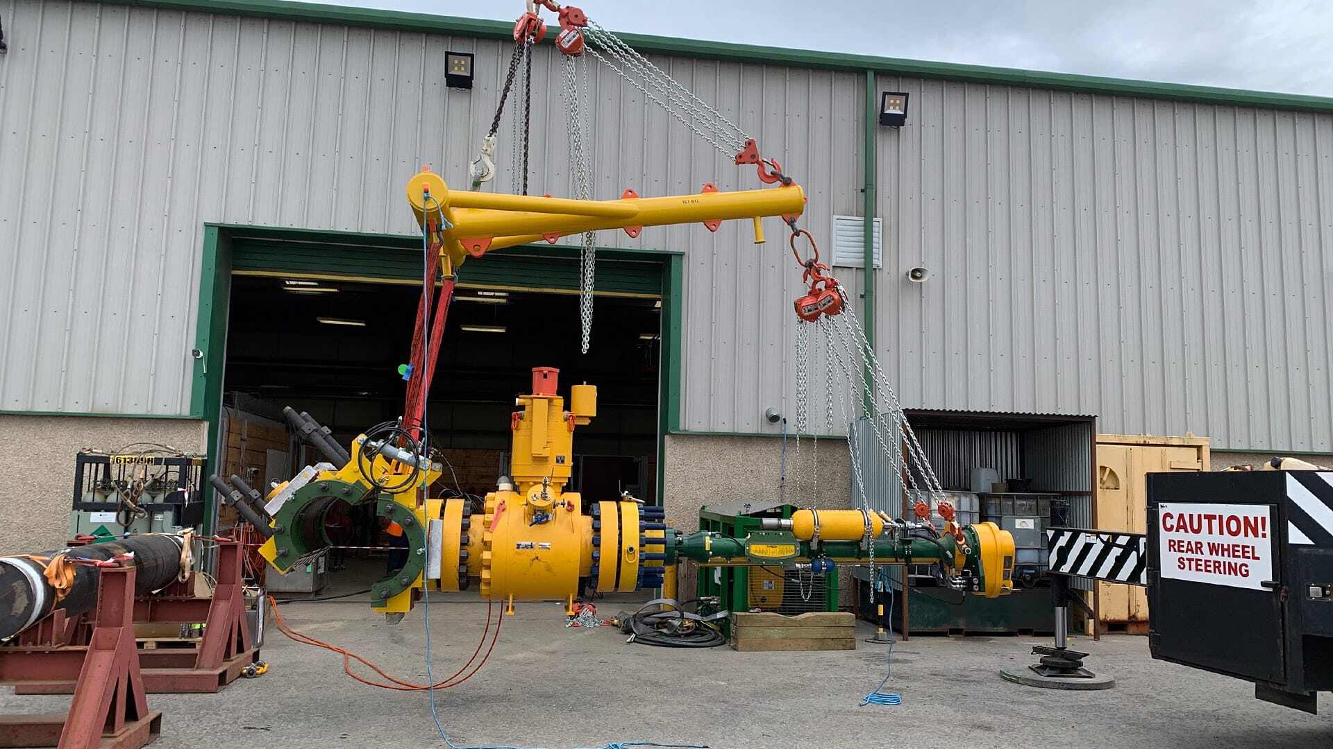 Subsea Mechanical Clamp being lowered into place in a yard