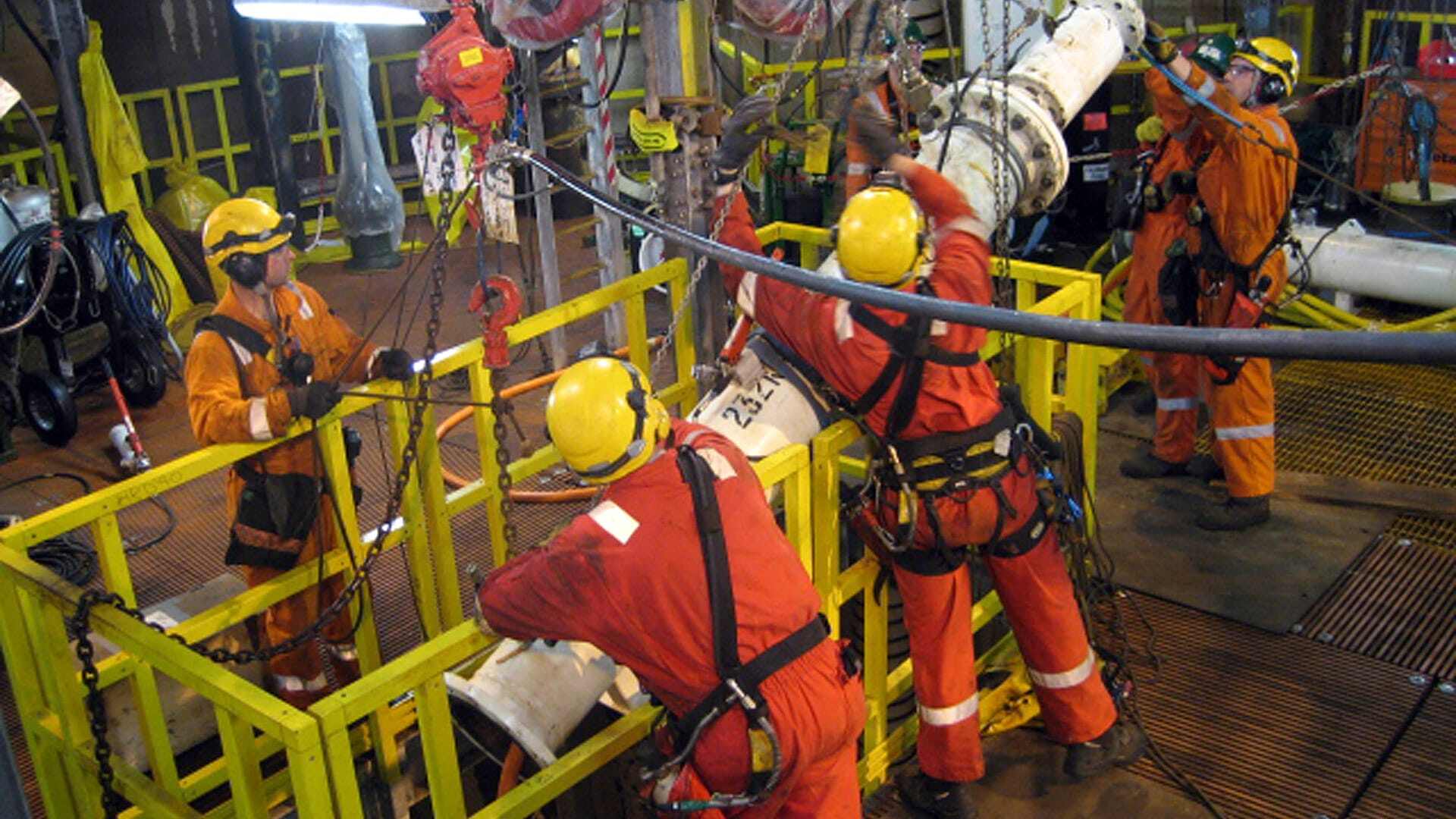 Engineers lifting equipment together