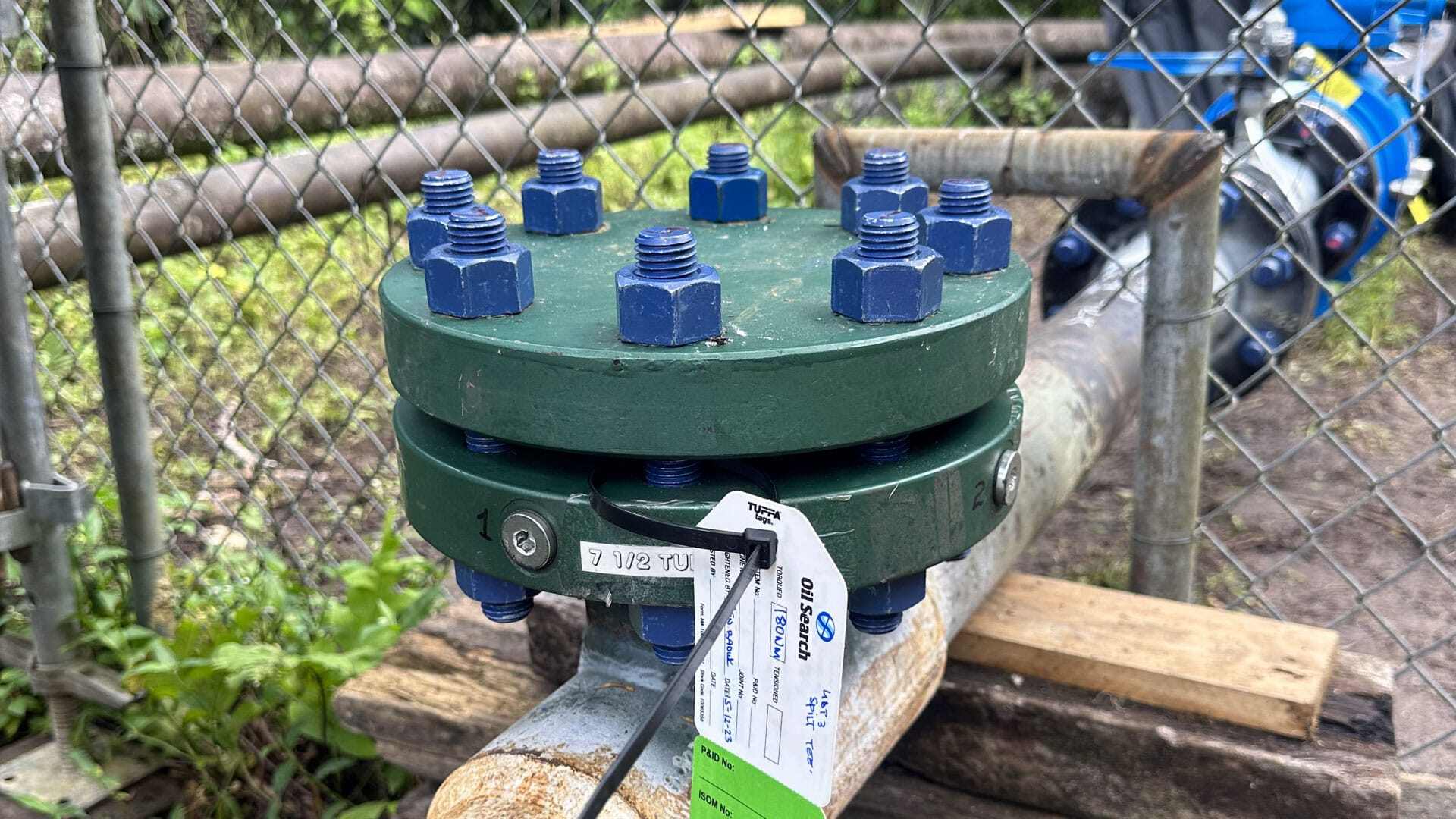 Close up of a completion plug and blind flange installed on a pipeline in Papa New Guinea