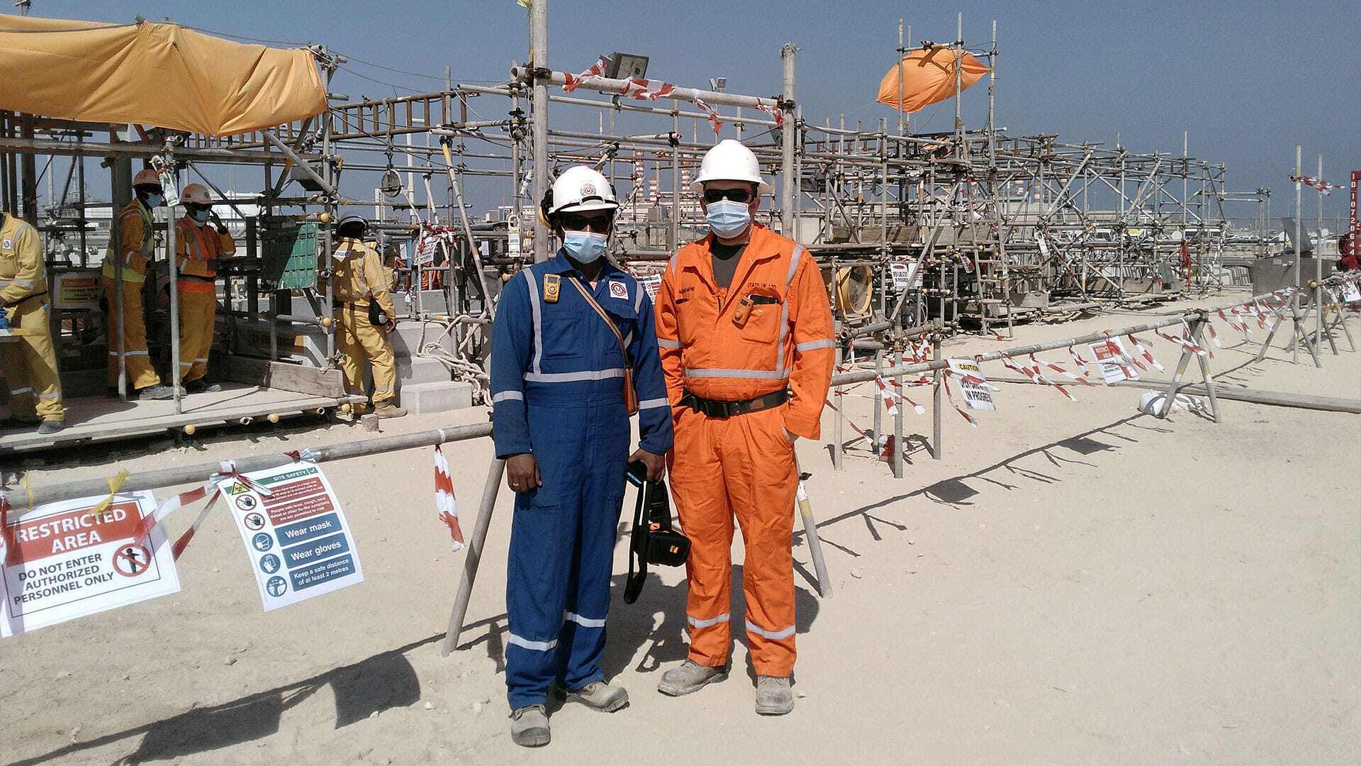 Two team members posing infront of Tecno Plug pipeline work